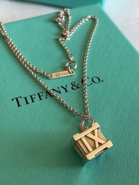 Tiffany & Co. Sterling Silver Roman Numeral Cube Necklace on Blue